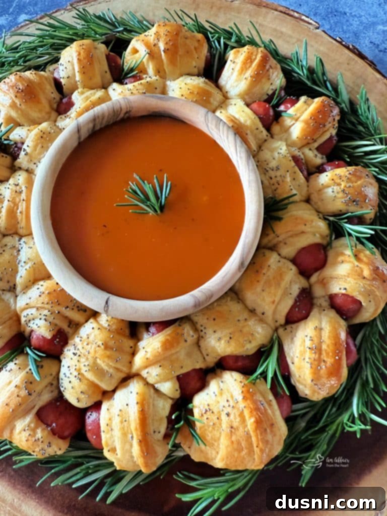 Pull-Apart Pigs in a Blanket Wreath 14 Another beautiful shot of the golden Pigs in a Blanket Wreath, featuring Dorothy Lynch dressing as a dipping sauce.