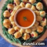 Pull-Apart Pigs in a Blanket Wreath 19 Dorothy's Pigs in a Blanket Wreath on a wood stump serving platter