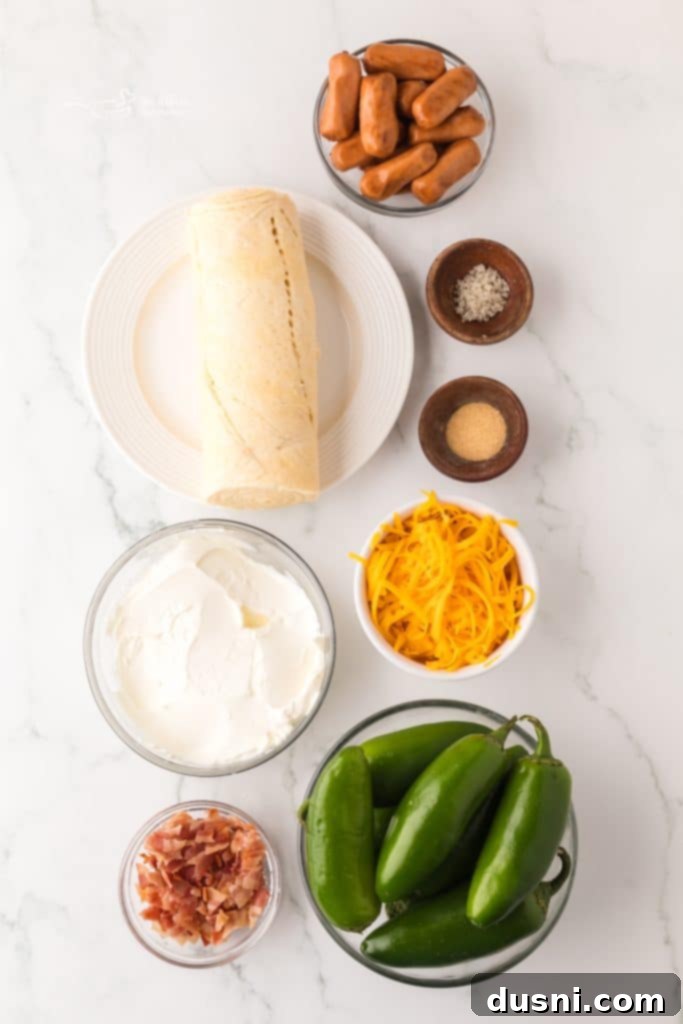 A close-up shot of several freshly baked Jalapeño Popper Pigs in a Blanket arranged neatly on a rustic wooden cutting board, ready for serving.
