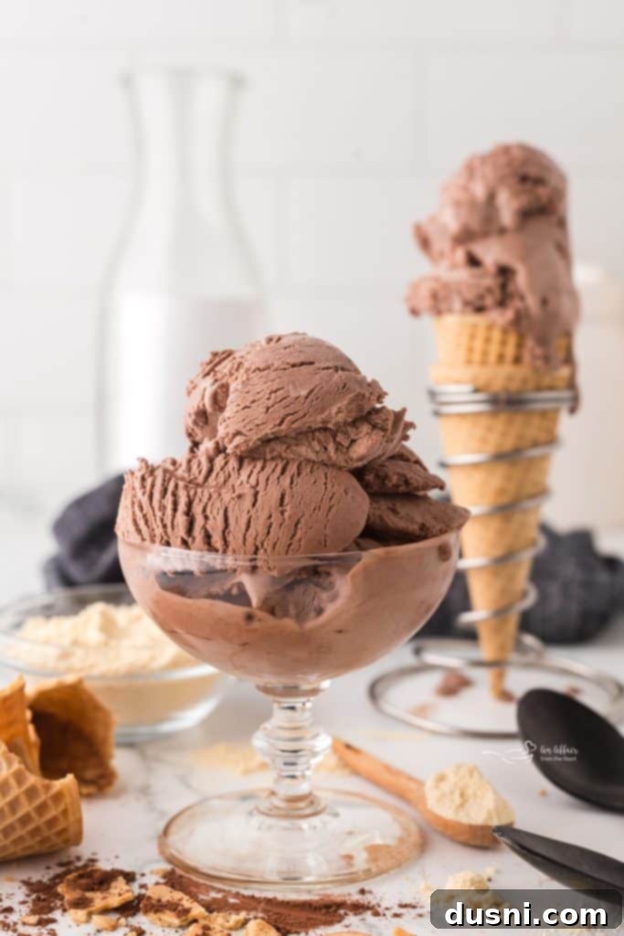 Two scoops of no-churn chocolate malt ice cream in a double waffle cone.
