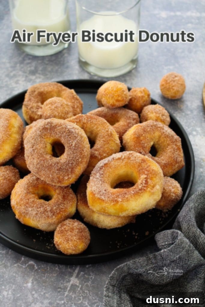 Golden Air Fryer Biscuit Doughnuts 15 Hero shot of a basket full of air fryer biscuit donuts.