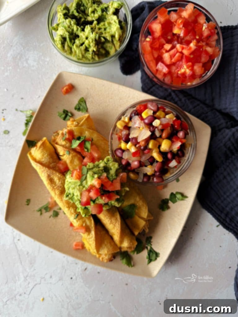 Close-up of a golden-brown, perfectly rolled Chicken and Cowboy Caviar Taquito ready for dipping.