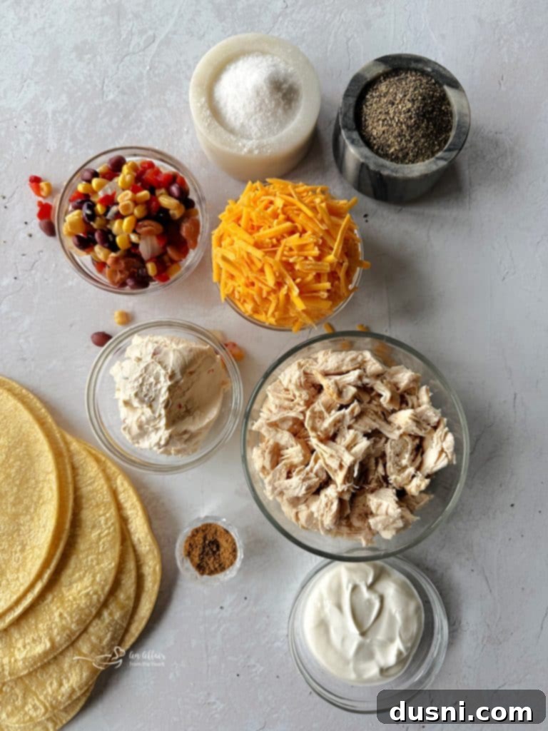 Prepared Chicken and Cowboy Caviar Taquitos laid out neatly on a baking sheet before cooking.