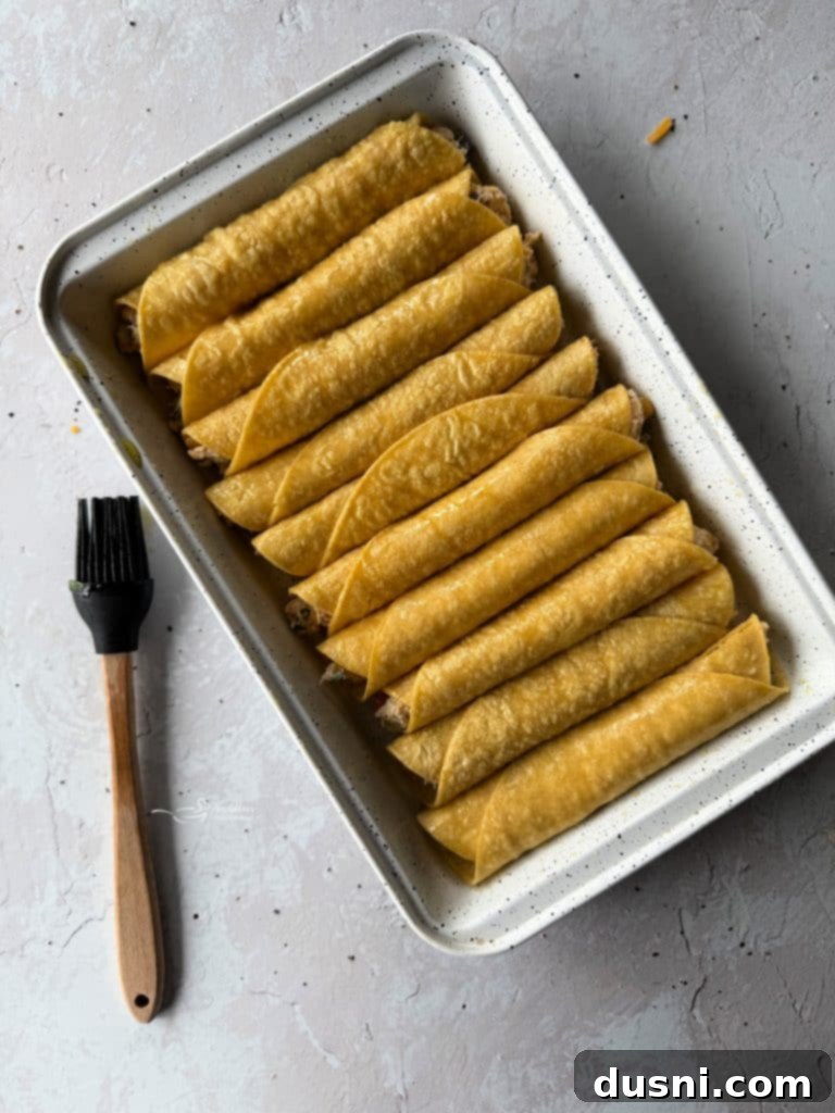 A rolled taquito with the savory filling clearly visible, illustrating the rolling technique.
