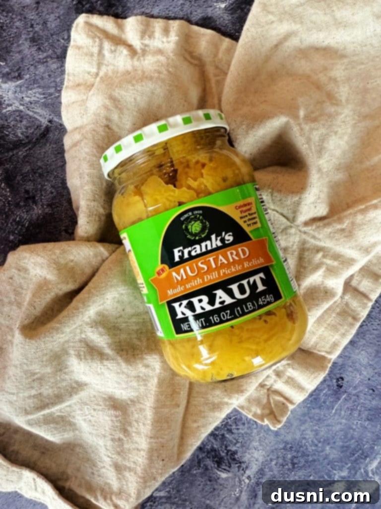 A close-up shot of the finished Bratwurst Sliders with melted cheese and kraut, ready to be served.