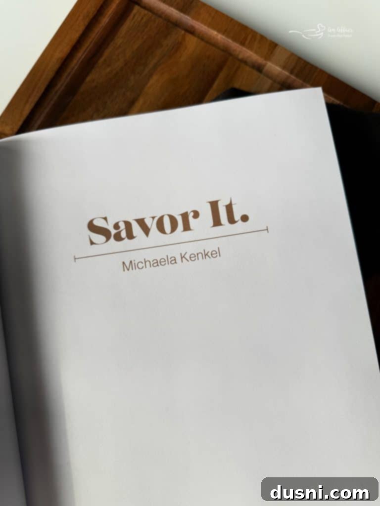 Close-up of the Savor It cookbook cover, displaying the title and a vibrant food photograph.