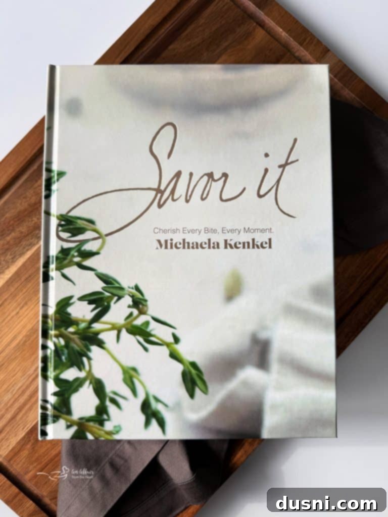Michaela Kenkel in her kitchen, surrounded by ingredients, ready to cook from Savor It.