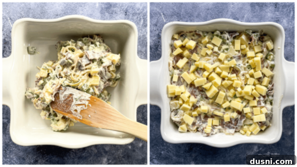 cheese steak dip in baking dish with wooden spoon
