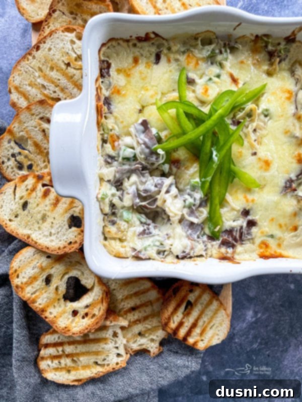 cheese steak dip in baking dish with peppers