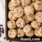 Tiny Chocolate Chip Delights 15 Mini Chocolate Chip Cookies stacked on a sheet pan, ready to eat.