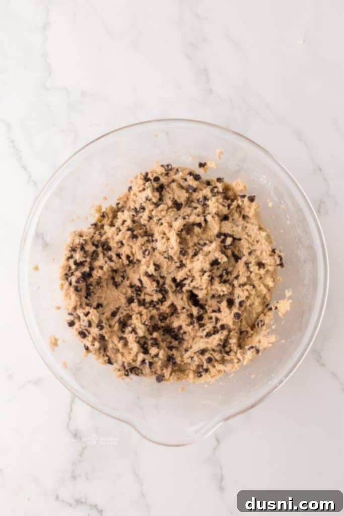 Tiny Chocolate Chip Delights 7 Bowl of ingredients for mini chocolate chip cookies, including flour, sugars, and chocolate chips.