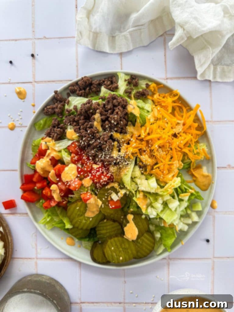 Big Mac Salad in a white bowl with a fork.