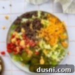 Close up of Big Mac Salad on a white plate.