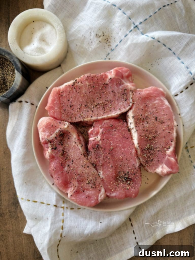 Fresh ingredients laid out for No Peek Pork Chops and Rice: pork chops, butter, mushrooms, onion soup mix, cream of mushroom soup, and uncooked rice.