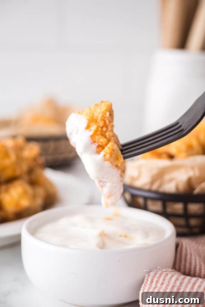 Hot Honey Glazed Crispy Popcorn Chicken 10 Hot Honey Popcorn Chicken on a plate with fries and a salad