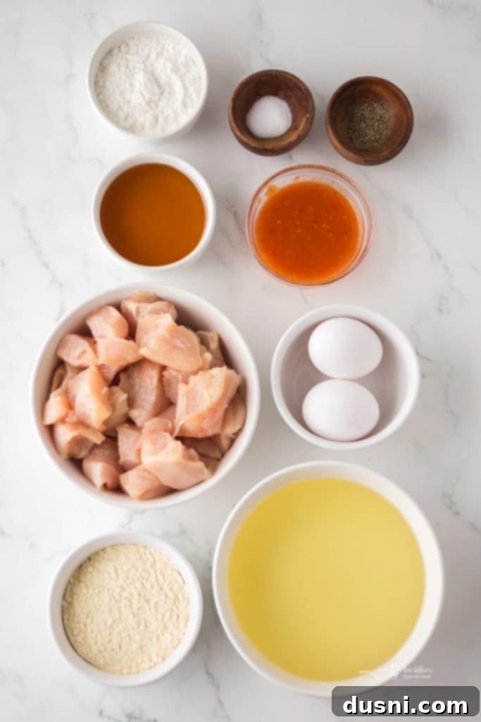 Hot Honey Glazed Crispy Popcorn Chicken 4 Ingredients for Hot Honey Popcorn Chicken laid out
