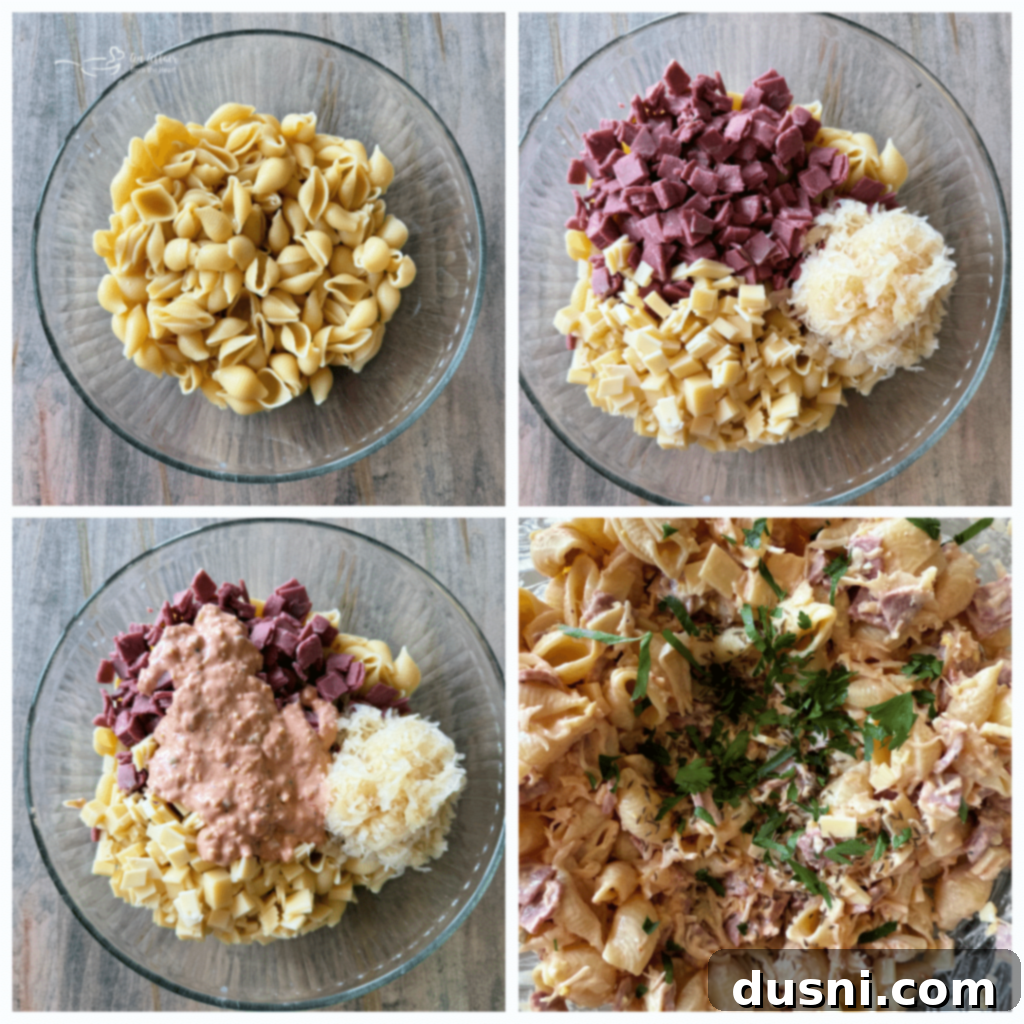 Reuben Pasta Salad being gently stirred in a large serving bowl.