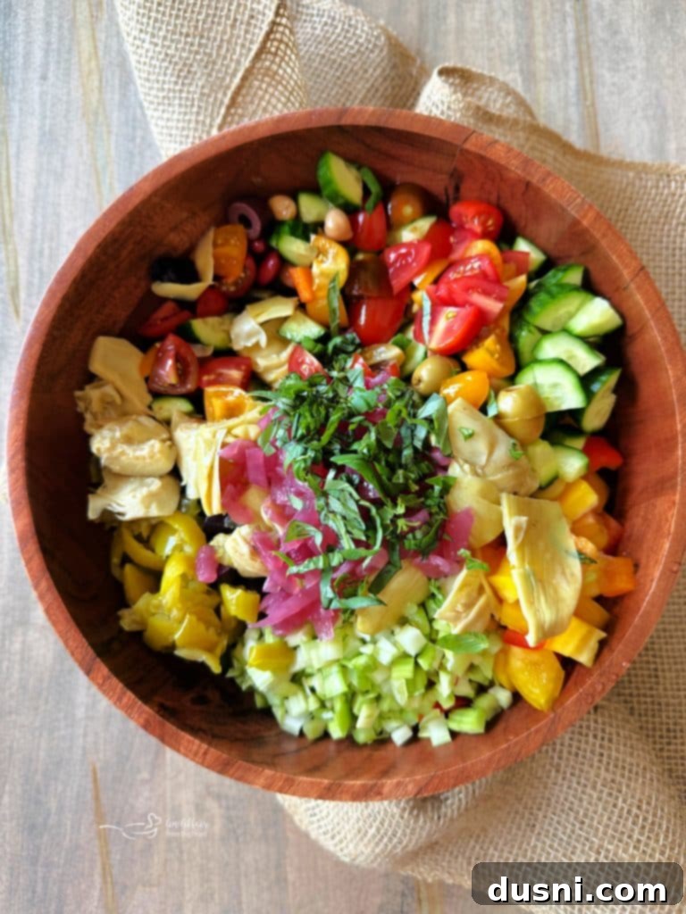 Chopped vegetables and Paisley Farm Five Bean Salad in a large bowl
