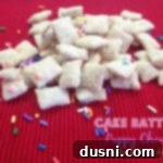 Cake Batter Funfetti Munch 2 cake batter puppy chow on a red surface with text "cake batter puppy chow"