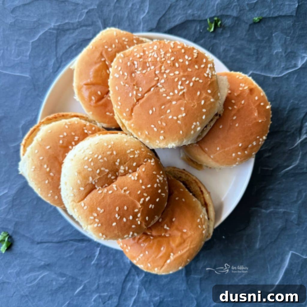 Mexican Street Burgers 14 Grilled Mexican hamburgers with melted cheese on the grill.