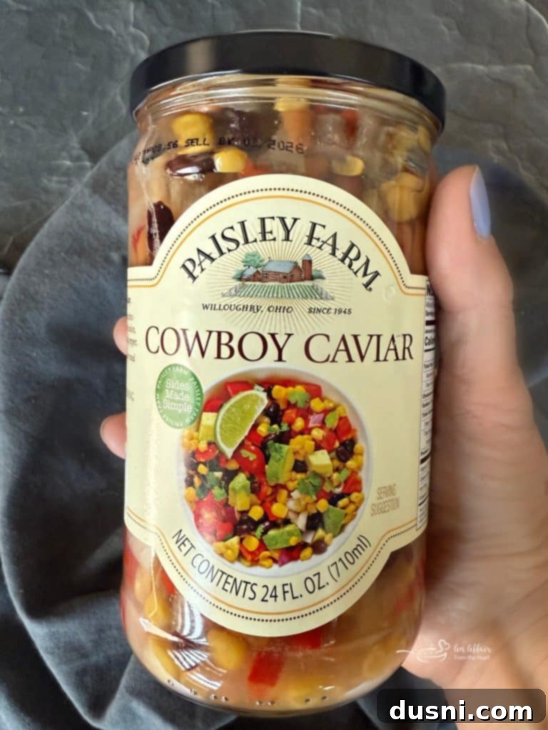 Mexican Street Burgers 16 A jar of Paisley Farm Cowboy Caviar in a kitchen setting.