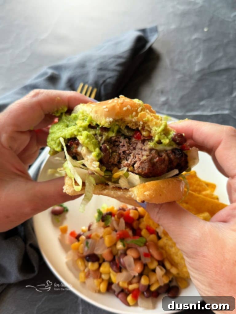 Mexican Street Burgers 3 Close-up of a grilled Mexican hamburger patty with melted cheese.