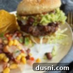 Mexican Street Burgers 20 Side view of Mexican Hamburgers on a white plate.