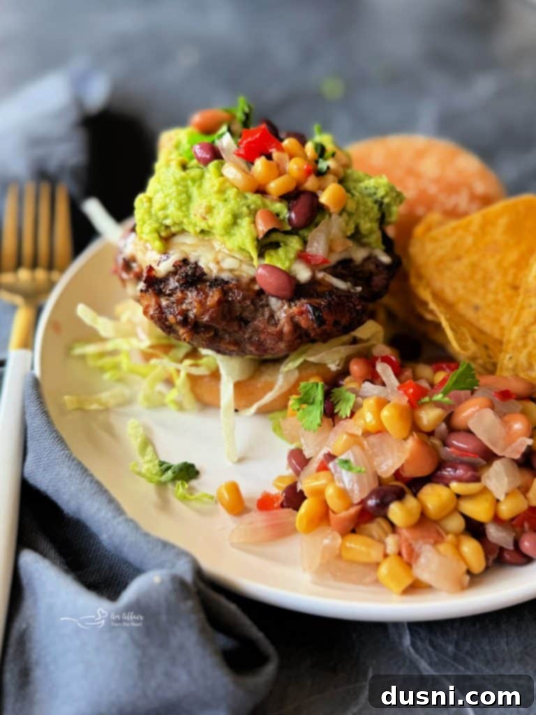 Mexican Street Burgers 4 A prepared Mexican hamburger on a toasted bun, with fresh toppings.