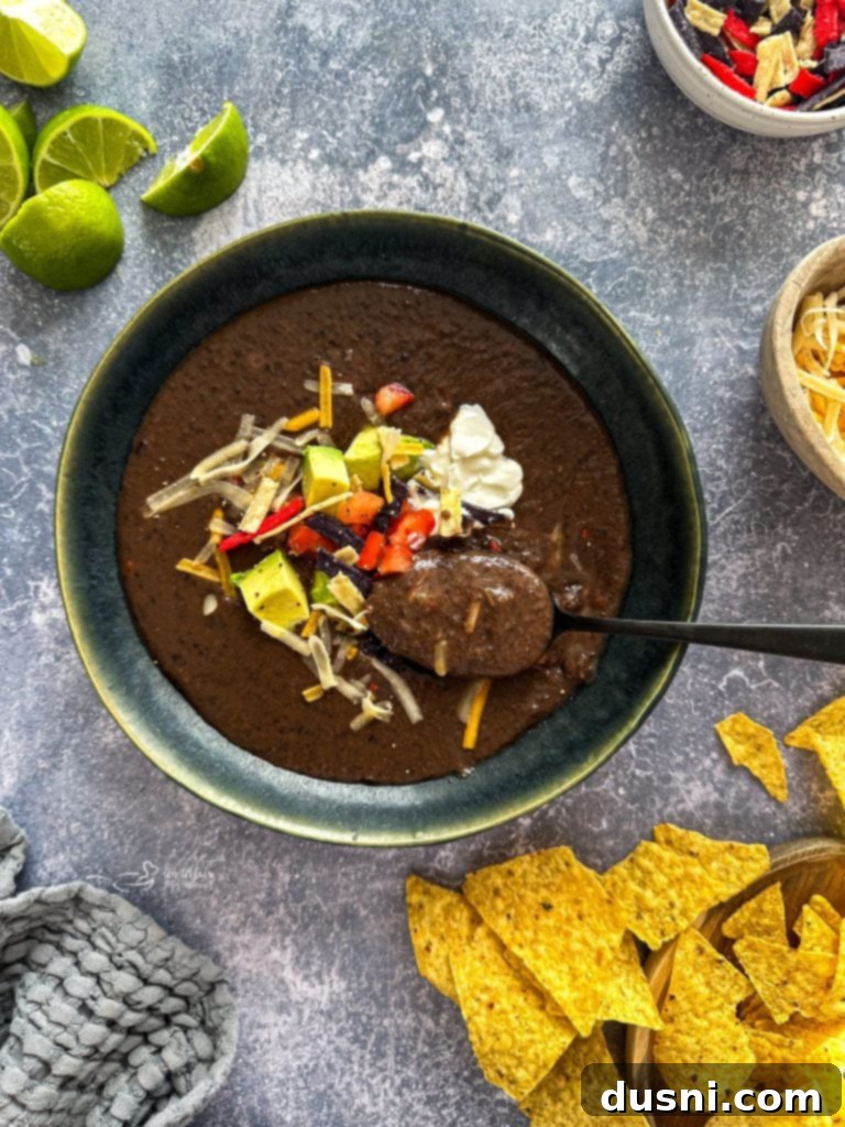 Hearty Black Bean Soup Made Simple 2 A steaming bowl of creamy black bean soup with fresh cilantro and a dollop of sour cream.