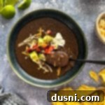 Hearty Black Bean Soup Made Simple 15 Taking a spoonful of black bean soup.