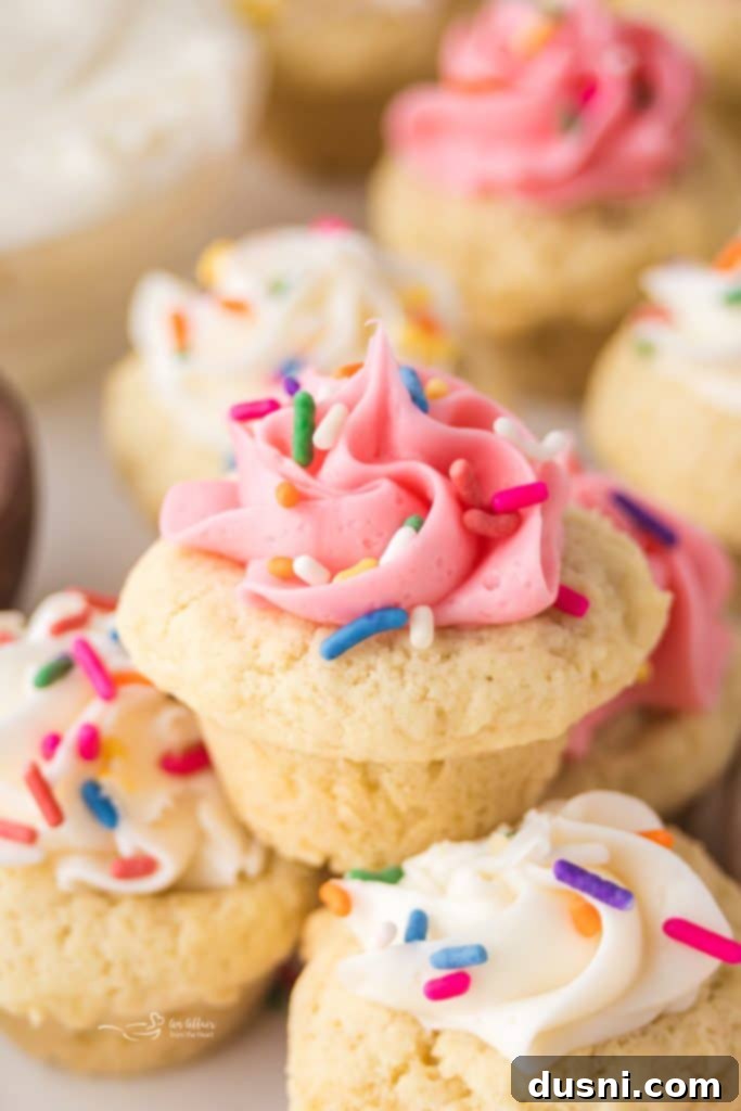 Delicious Frosted Sugar Cookie Cups 2 Close up of a pink frosted Sugar Cookie cup topped with rainbow sprinkles.