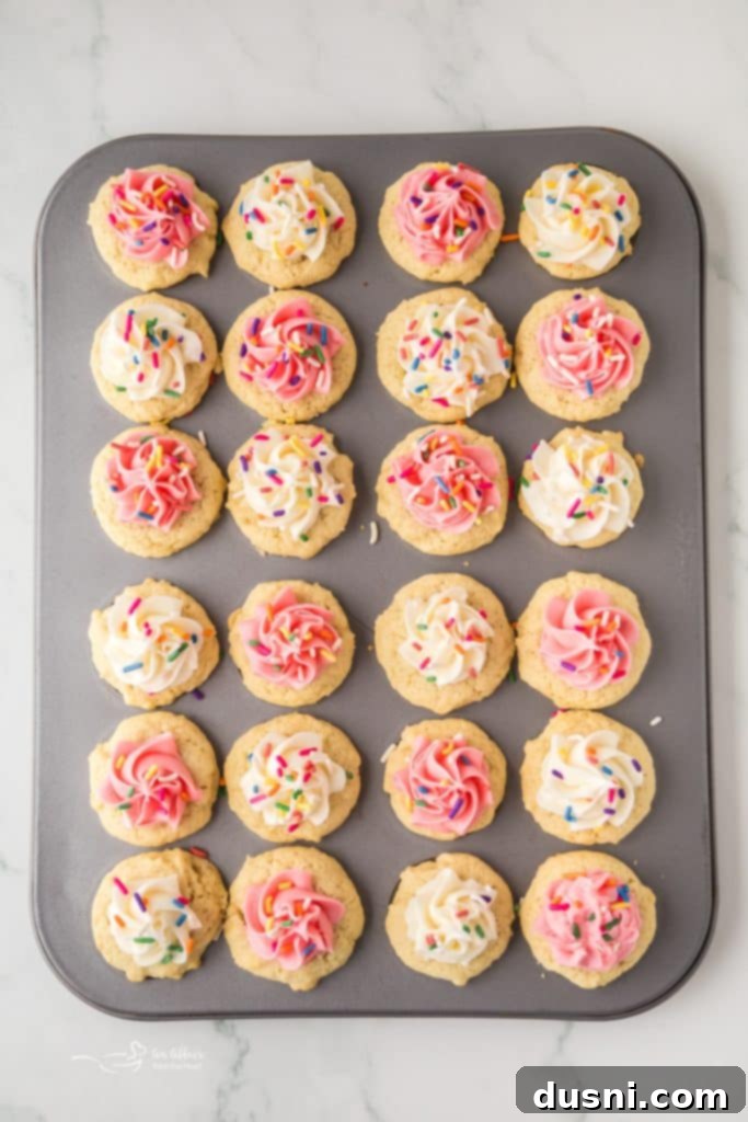 Delicious Frosted Sugar Cookie Cups 8 A tray of baked sugar cookie cups with indentations.