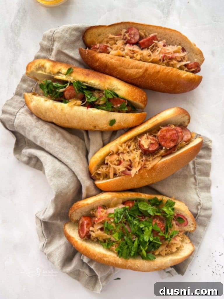 Four Kielbasa and Sauerkraut Hoagies arranged on a serving board with a cozy, inviting backdrop.