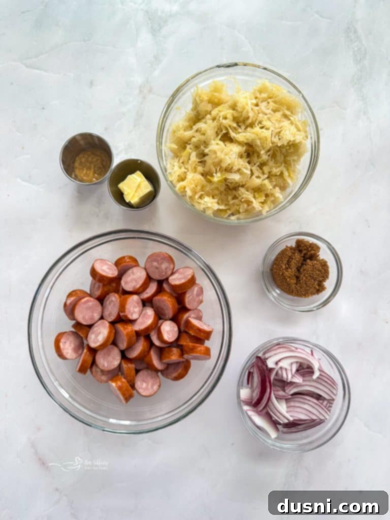 Ingredients for Kielbasa and Sauerkraut Hoagies laid out on a wooden cutting board.