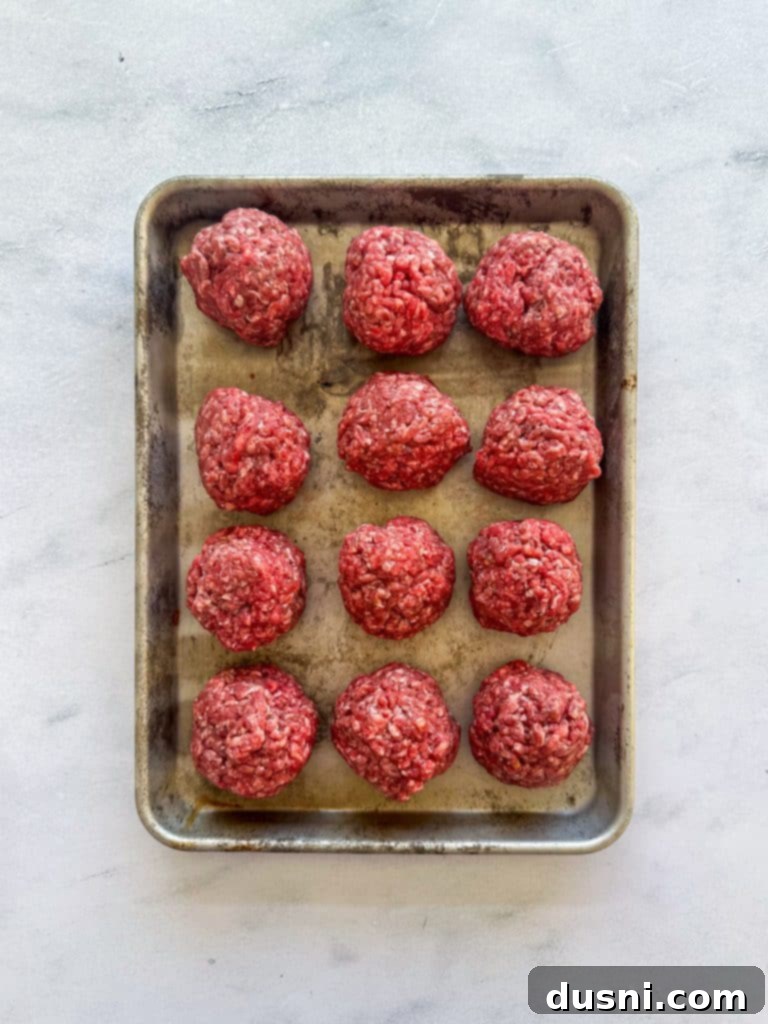Ground beef divided into thin patties, seasoned with salt and pepper.