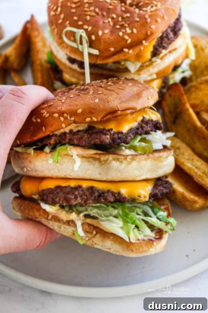 Close-up of the delicious layers of a homemade Big Mac, showcasing the melted cheese and fresh vegetables.