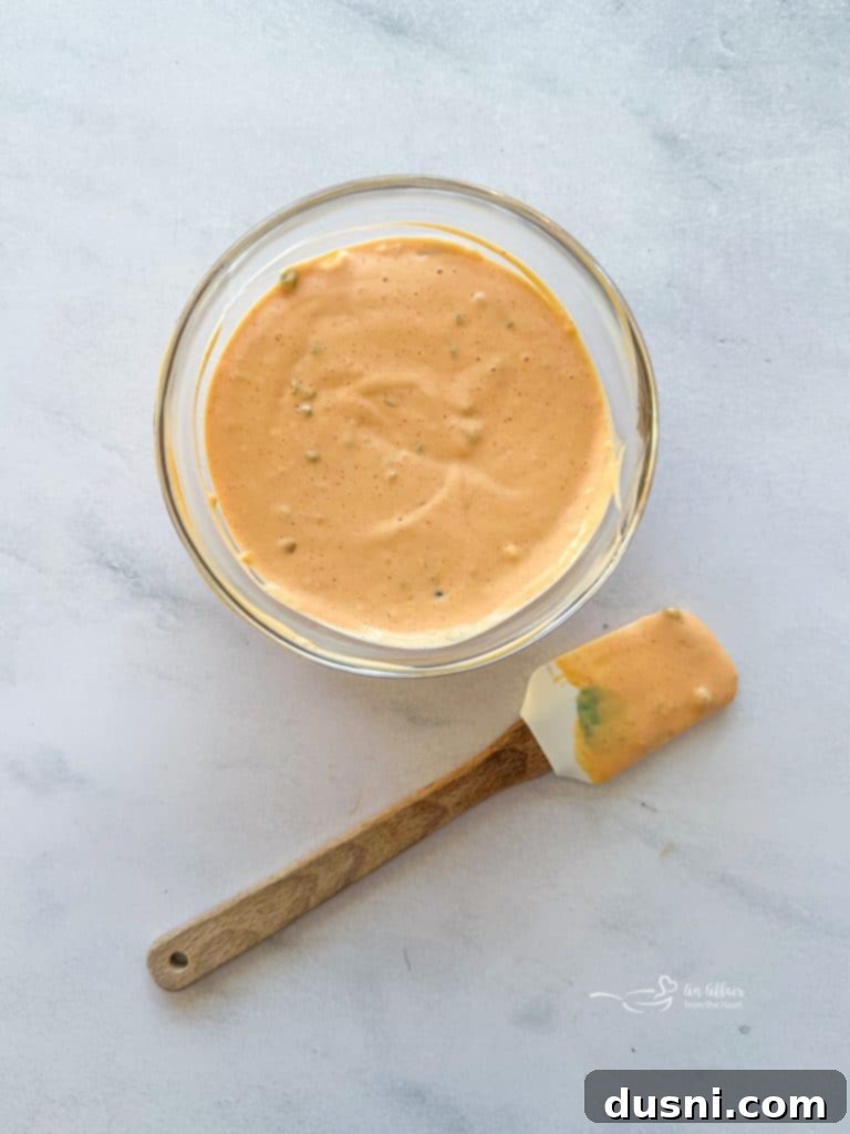 A bowl of the creamy, tangy homemade Big Mac sauce, ready to be spread on burgers.