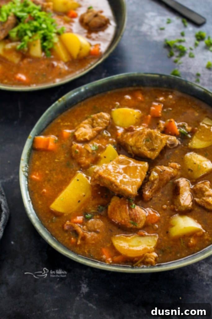 Hearty Pork Stew 3 Pork Stew with chunks of pork, potatoes, and carrots, ready to be served.