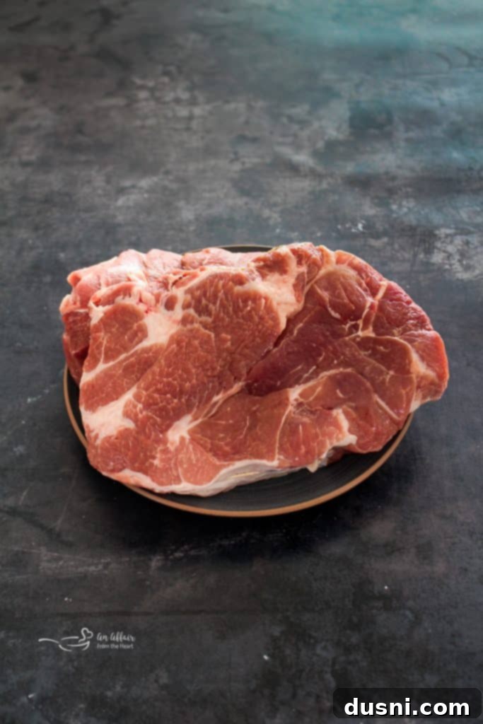 Hearty Pork Stew 4 Close-up of golden brown pork chunks searing in a Dutch oven.
