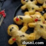 Mystic Doll Pastries 16 Close up of Voodoo Doll Hand Pies with cherry filling peeking out.