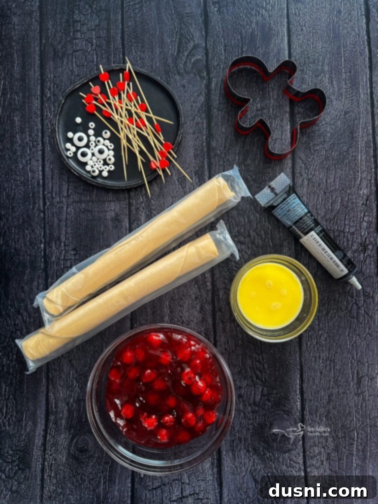 Mystic Doll Pastries 6 Multiple Voodoo Doll Hand Pies on a white tray, showcasing their varying decorations and cherry filling.