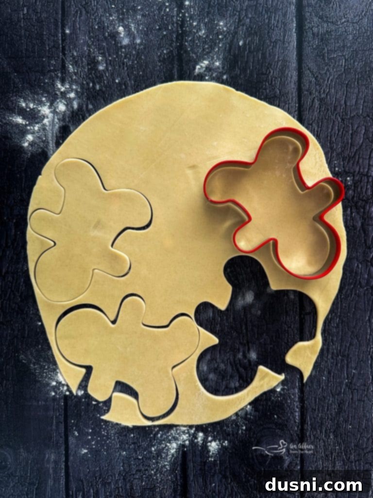 Mystic Doll Pastries 8 Rolling out pie crust on a floured surface with a rolling pin.