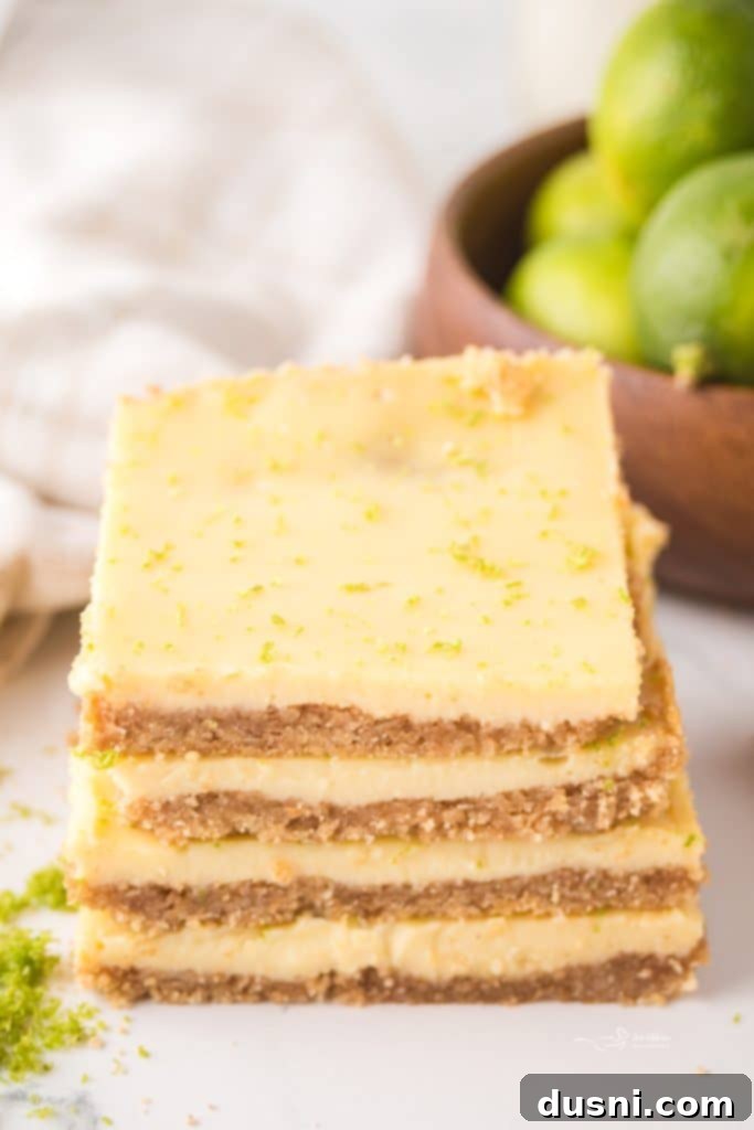Zesty Key Lime Pie Bars 3 Key Lime Pie Bars neatly arranged on a white serving platter.