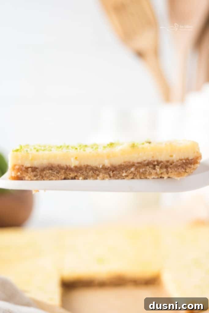 Zesty Key Lime Pie Bars 4 A close-up of a Key Lime Pie Bar showing the textured crust and smooth filling.