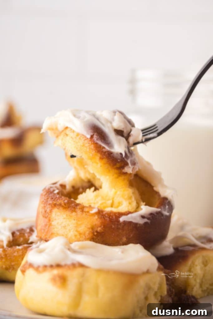 Air Fryer Cinnamon Roll Perfection 2 Freshly baked air fryer cinnamon rolls with cream cheese frosting.