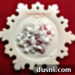 double chocolate peppermint puppy chow on a white snowflake serving platter