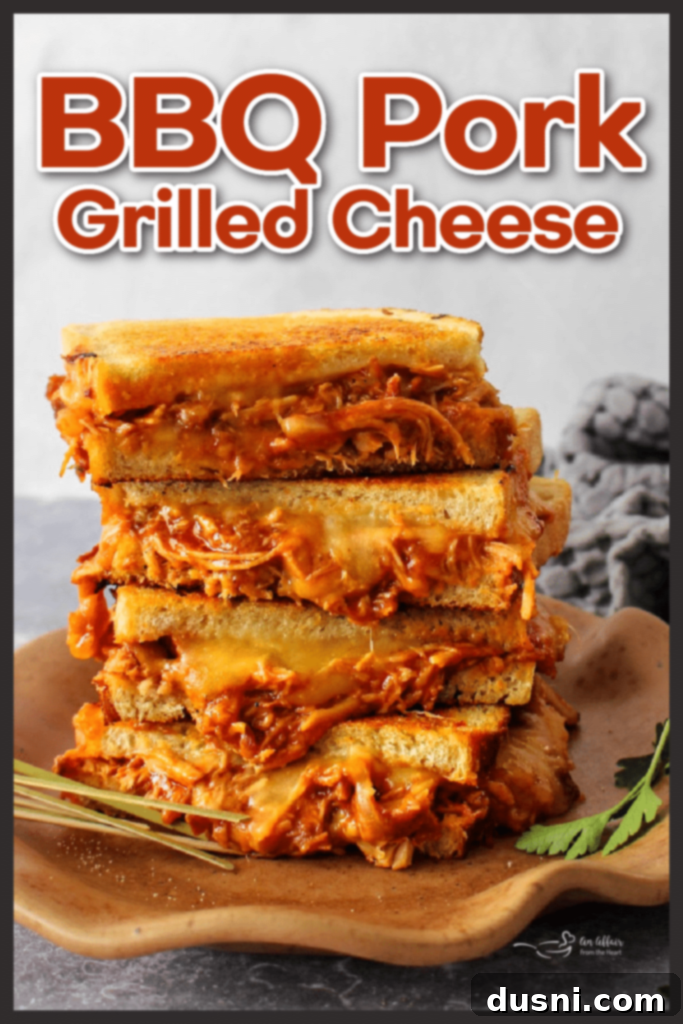 A perfectly golden-brown BBQ Pulled Pork Grilled Cheese sandwich, ready to be enjoyed.