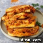 Close up of BBQ Pork Grilled Cheese, showing the golden-brown bread and gooey cheese.