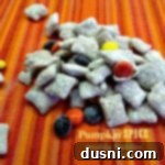 Cozy Pumpkin Spice Muddy Buddies 2 Pumpkin Spice Muddy Buddies on a striped table cloth