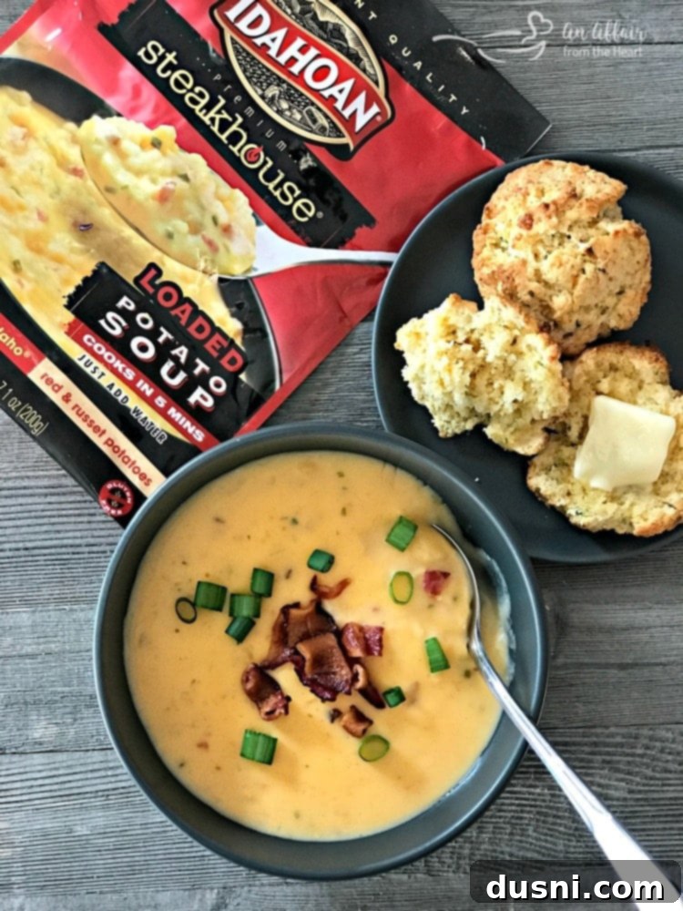 A serving of Cheesy Cornbread Drop Biscuits alongside a hearty bowl of soup and salad